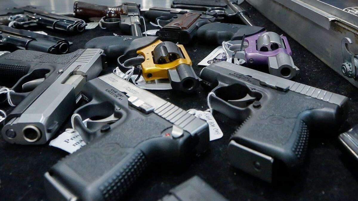 Handguns, many of them semiautomatic, are displayed on a vendor's table at a gun show in Albany, N.Y., in 2013.
