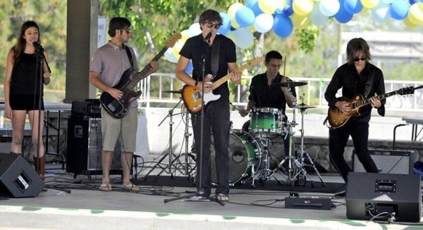 Ryder Buck, center, performs with members of The Ryder Buck Band at Memorial Park in La Canada in 2012. He was killed Sunday after two cars struck him as he stepped out onto the 2 Freeway.