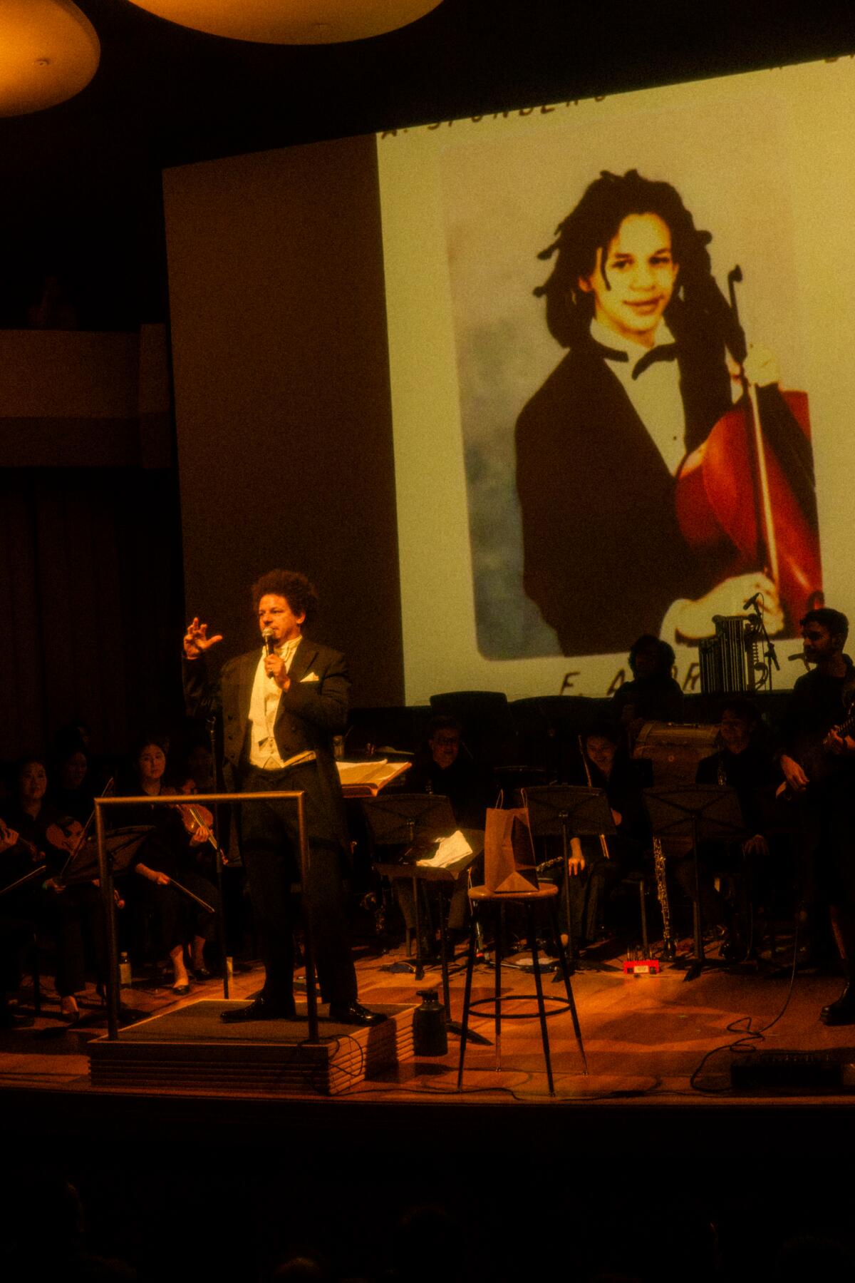 Eric André projects a photo of him as a young classical music student during his recent show in L.A.