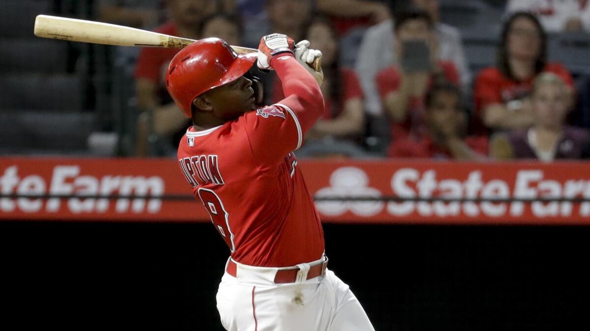 Justin Upton hits a home run for the Angels against the Seattle Mariners in September. Upton is set to come off the injured list Monday.