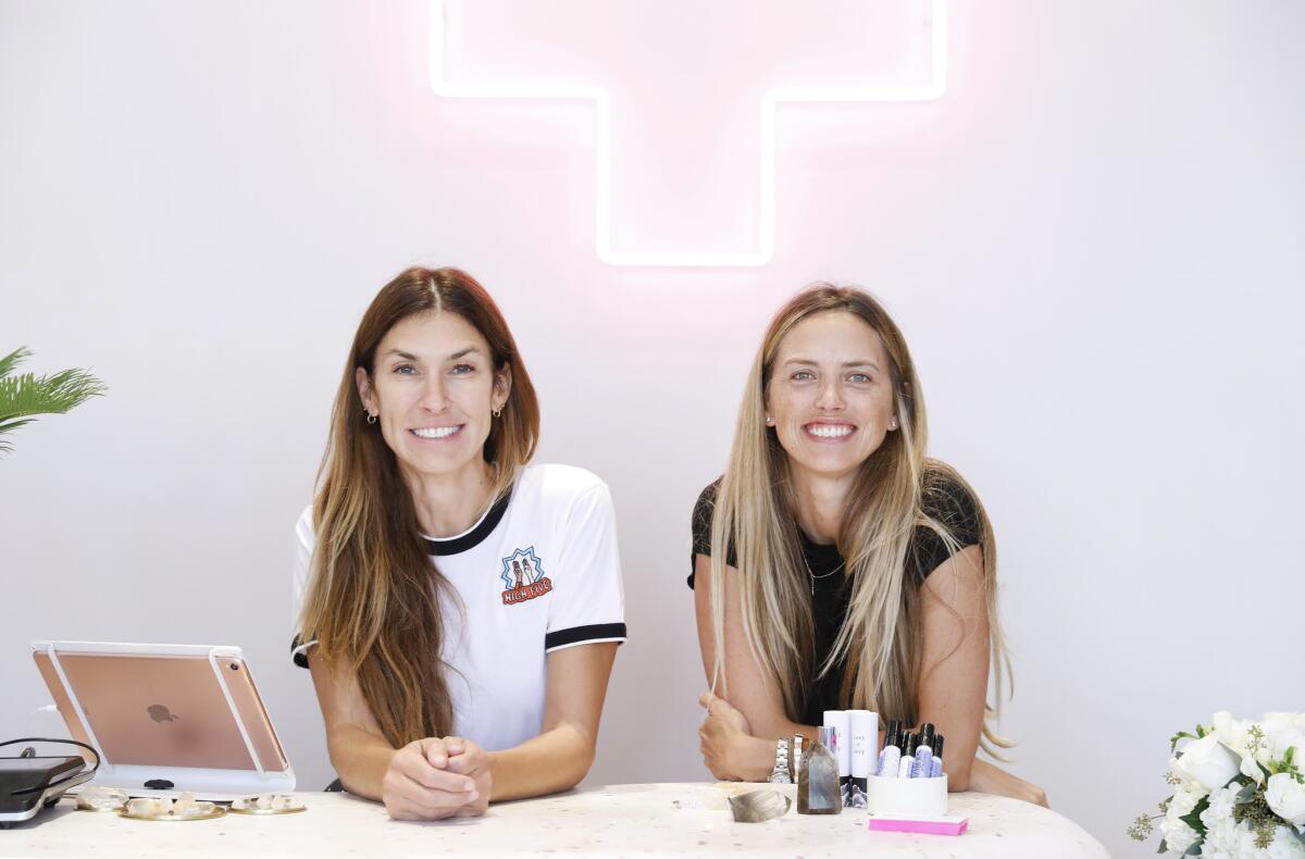 Botanica Bazaar founders Bethany Mayer, left, and Leilani Bishop inside their shop at Palisades Village in Pacific Palisades.