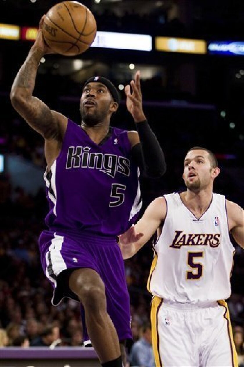 Sacramento Kings' Bobby Brown (5) shoots a layup while being guarded by Los Angeles Lakers' Jordan Farmar during the first half of an NBA basketball game on Sunday, Nov. 23, 2008, in Los Angeles. (AP Photo/Jeff Lewis)