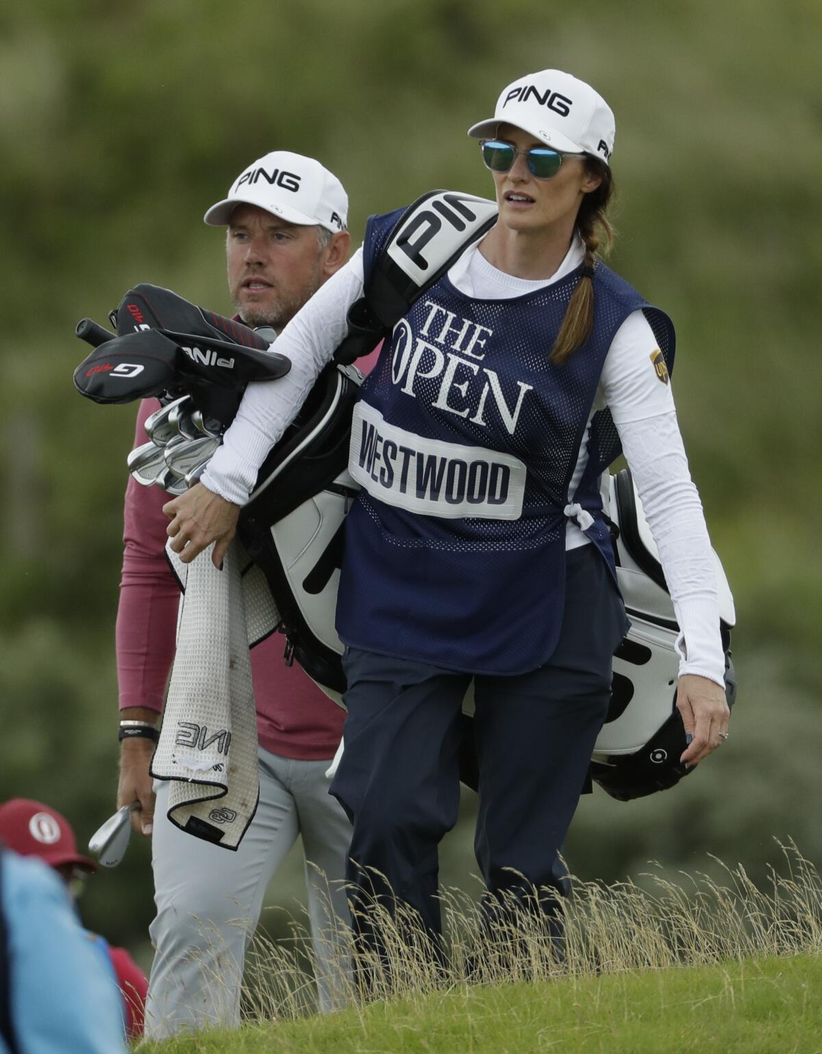 England's Lee Westwood with his caddie and girlfriend Helen Storey walk to the fifth hole.