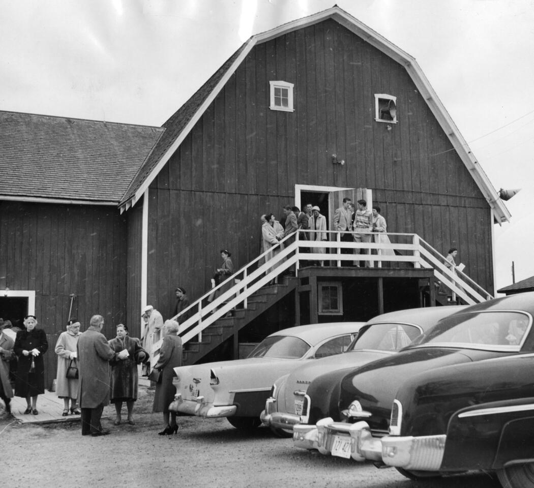 1957: People leave after services at the "Church in the Barn," or Community Church of Rolling Meadows. The church was organized about a week before the city received its charter in 1955. The congregation consisted of about 50 families.