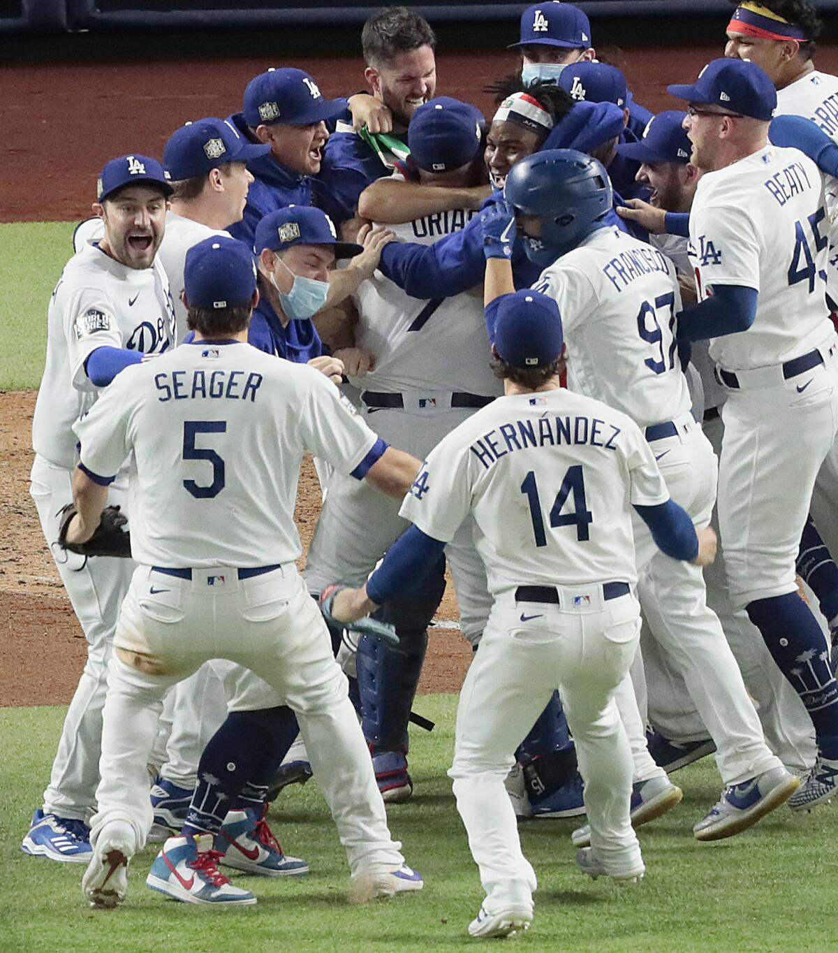 Julio Urias is mobbed by teammates after the World Series Game 6 victory.