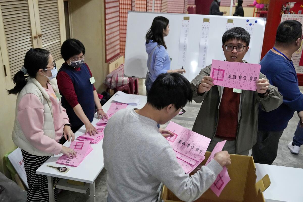 poll workers count votes in Taiwan