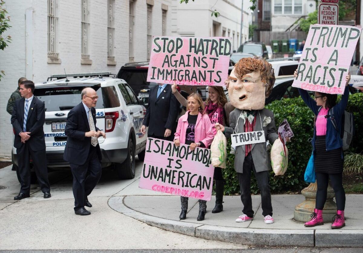 Demonstrators protest against Donald Trump outside the Republican National Committee headquarters in Washington on May 12 as he meets with House Speaker Paul D. Ryan.