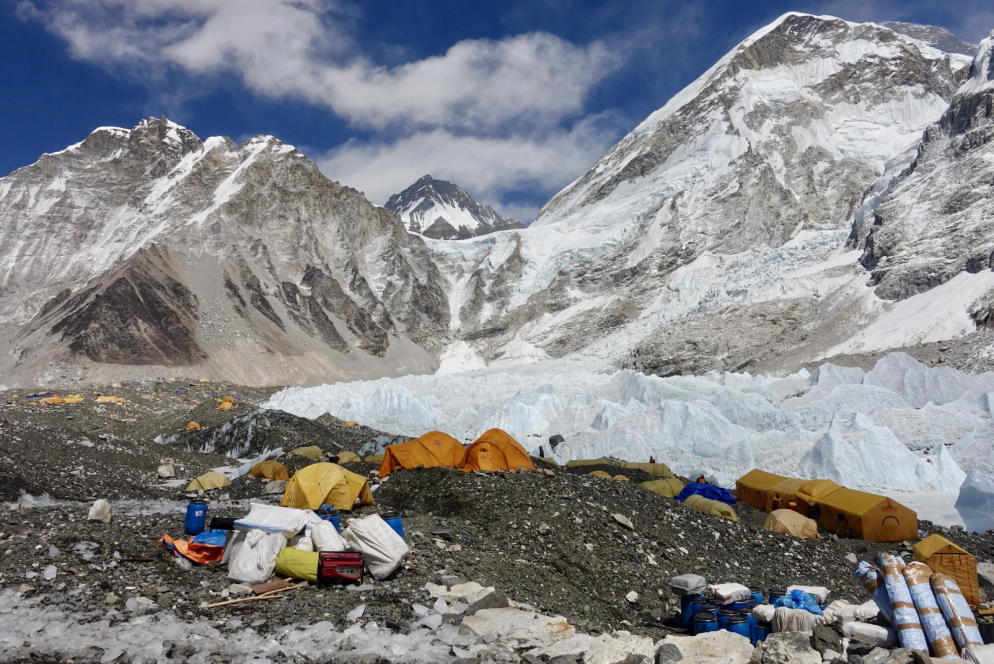 A collection of tents and mountaineering equipment in the icy Himalayas
