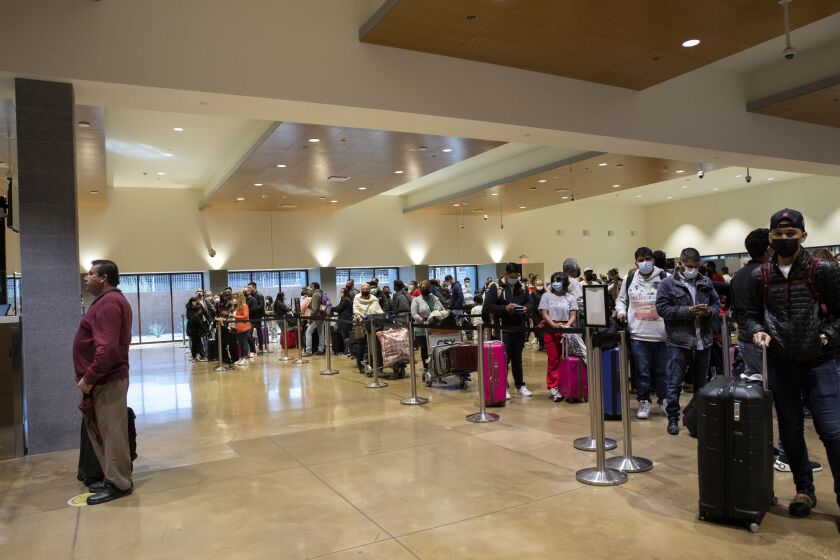 San Diego, California - January 20: People wait in line at the U.S. Customs and Border Protection area of Cross Border Xpress heading into San Diego on Thursday, Jan. 20, 2022 in San Diego, California. The port of entry was recently expanded by 6, 495 square feet. (Ana Ramirez / The San Diego Union-Tribune)