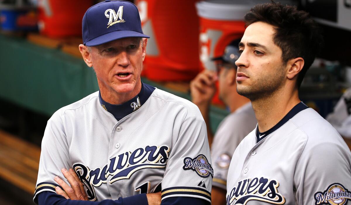 Ron Roenicke, left, talks with Brewers outfielder Ryan Braun during a game in Pittsburgh on April 18.