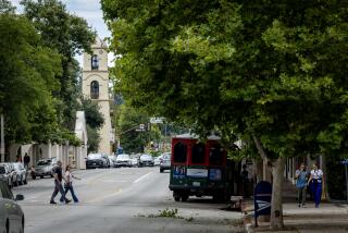 Ojai, CA - August 21: People walk across the street downtown Ojai, where a 5.1 earthquake occurred amid a historic tropical storm Hilary in Ojai Monday, Aug. 21, 2023. (Allen J. Schaben / Los Angeles Times)