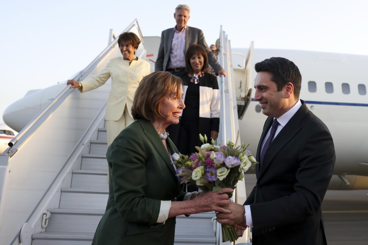 Head of Armenian National Assembly Alen Simonyan, right, welcomes U.S. House of Representatives Nancy Pelosi upon her arrival at the International Airport outside of Yerevan, Armenia, Saturday, Sept. 17, 2022. A US Congressional delegation headed by Speaker of the House Nancy Pelosi arrived Saturday in Armenia, where a cease-fire has held for three days after an outburst of fighting with neighboring Azerbaijan that killed more than 200 troops from both sides. (Photolure photo via AP)
