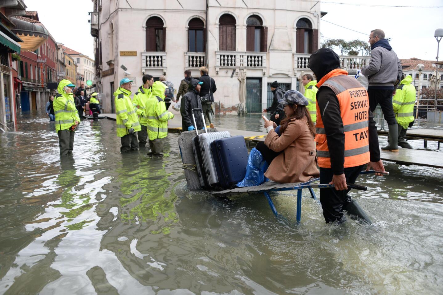 People wade through high water in Venice.