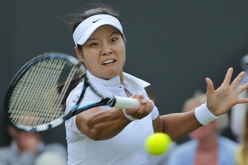 Li Na returns a shot during her second-round victory over Yvonne Meusburger at Wimbledon on Wednesday.