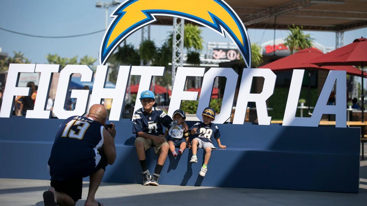 Sergio Ruiz photographs his children, Sergio Jr., Christian and Diego, at the StubHub Center, new home of the Chargers.