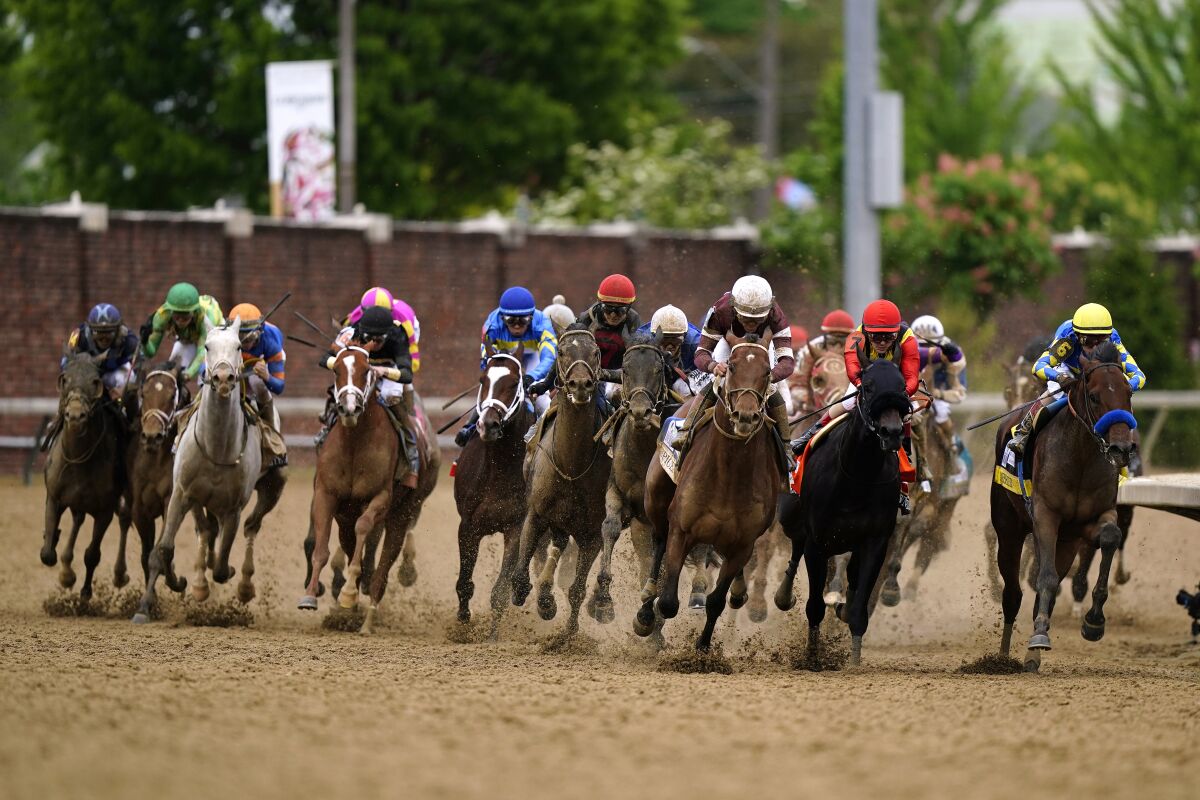 Horses round the fourth turn during the 148th running of the Kentucky Derby horse race at Churchill Downs Saturday, May 7, 2022, in Louisville, Ky. (AP Photo/Brynn Anderson)