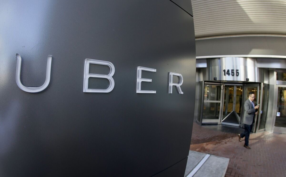 A man leaves the headquarters of Uber in San Francisco. 