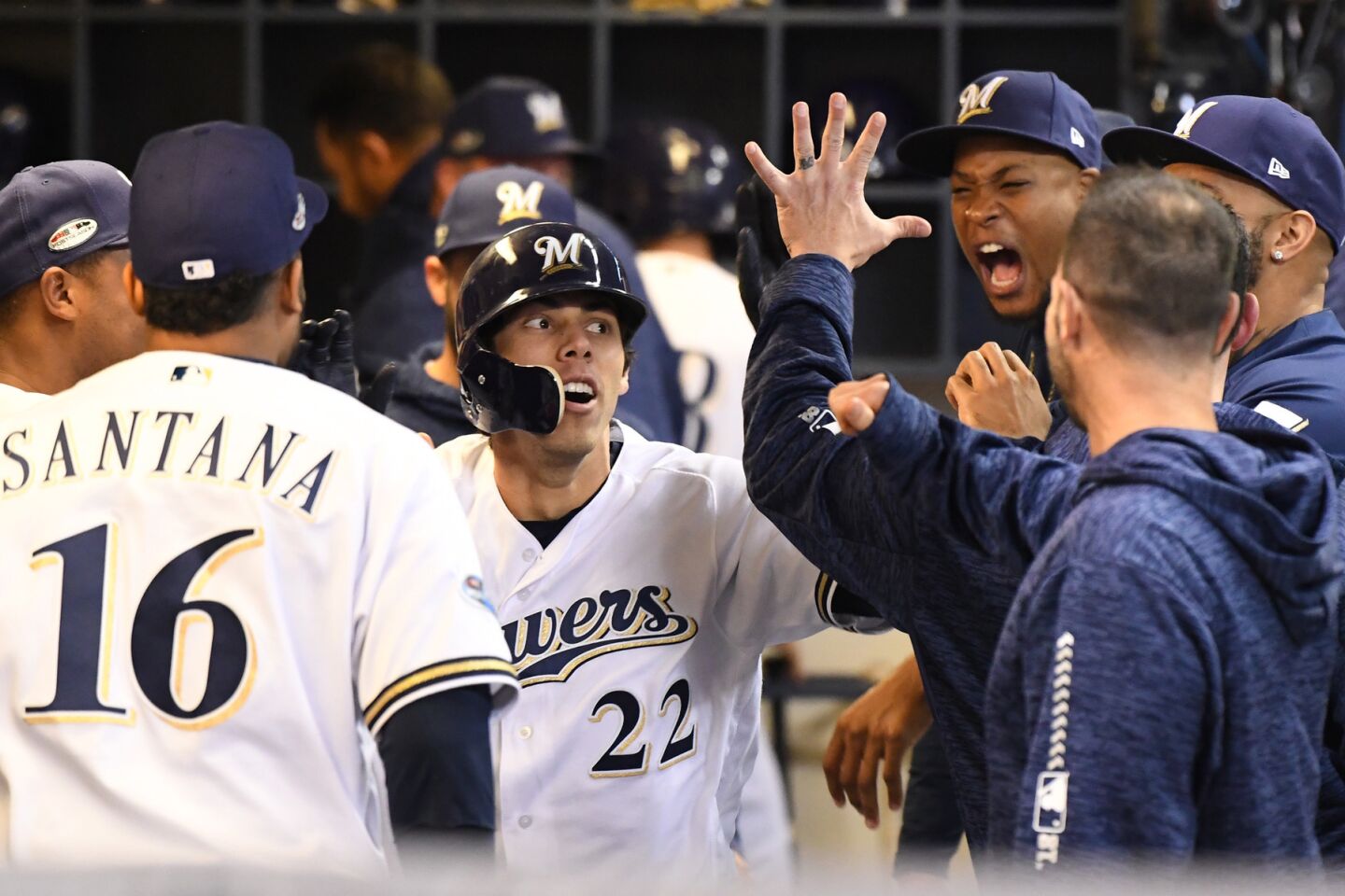 Milwaukee Brewers Christian Yelich celebrates in the dugout after hitting a solo homerun in the first inning.