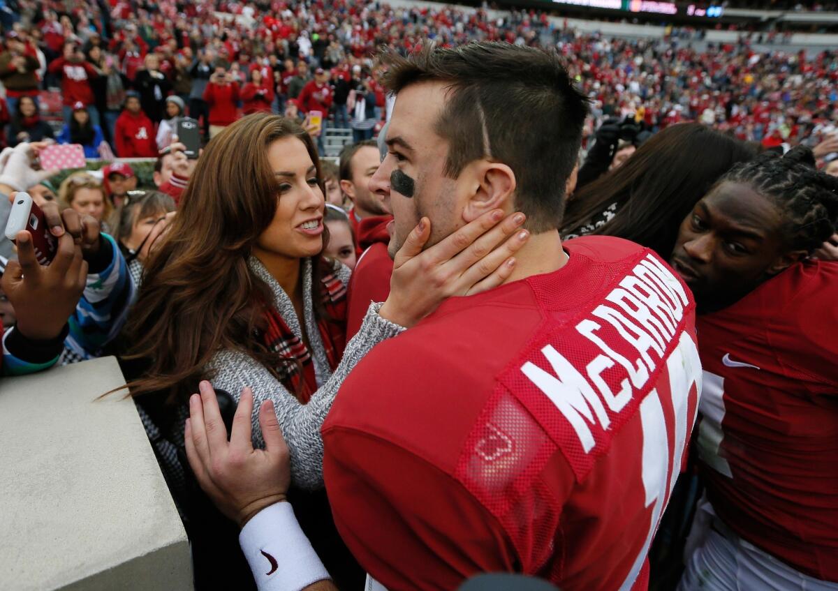 Former Alabama quarterback A.J. McCarron, shown with fiance Catherine Webb back in November, was drafted Saturday by the Cincinnati Bengals.