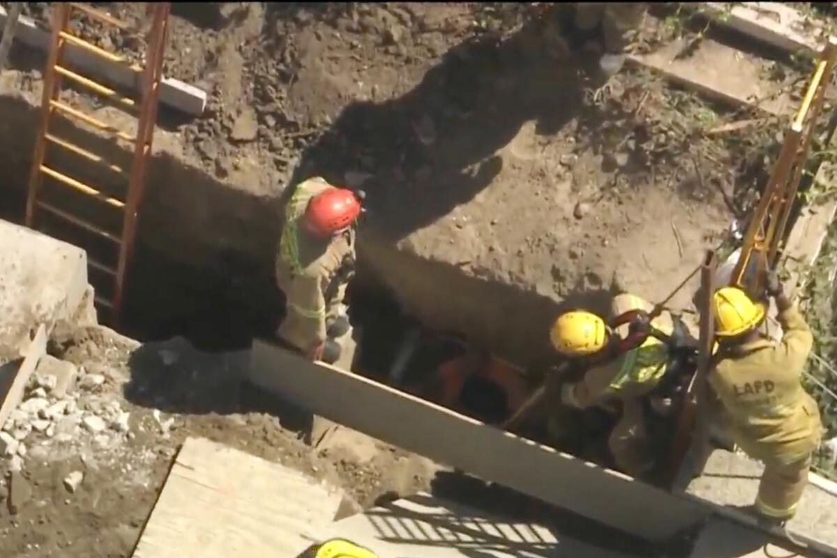 Firefighters in a trench during a rescue operation.