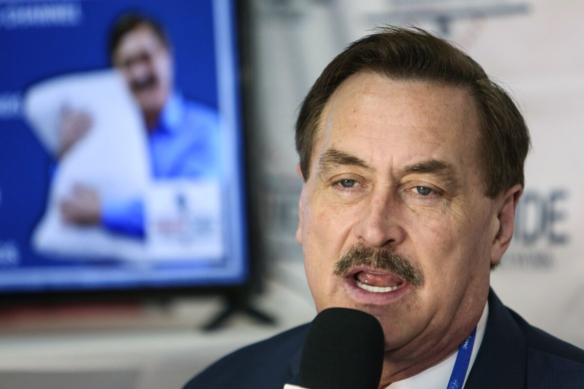 FILE - Founder and CEO of MyPillow Mike Lindell gives an interview with Right Side Broadcasting Network at the Conservative Political Action Conference in Orlando, Fla., on Feb. 28, 2021. A federal judge cleared the way Wednesday, Aug. 11 for a defamation case by Dominion Voting Systems to proceed against Trump allies Lindell, Sidney Powell and Rudy Giuliani, who had all falsely accused the company of rigging the 2020 presidential election. U.S. District Judge Carl Nichols handed down a ruling Wednesday that found there was no blanket protection on political speech. (Sam Thomas/Orlando Sentinel via AP, File)