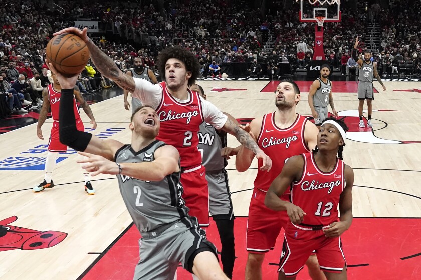 Chicago Bulls' Lonzo Ball (2) blocks the shot of Brooklyn Nets' Blake Griffin (2) during the second half of an NBA basketball game Wednesday, Jan. 12, 2022, in Chicago. The Nets won 138-112. (AP Photo/Charles Rex Arbogast)