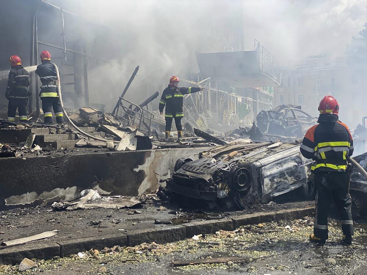 A firefighter stands amid the damage after shelling in Vinnytsia, Ukraine.