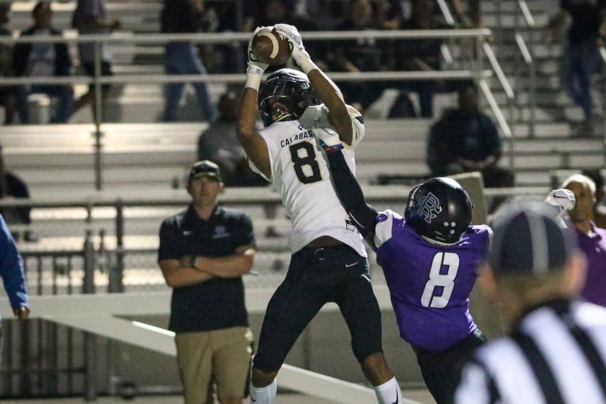 Calabasas wide receiver Amoni Butler catches a touchdown pass over Rancho Cucamonga's Jordan Webb during the second quarter of Thursday's game.