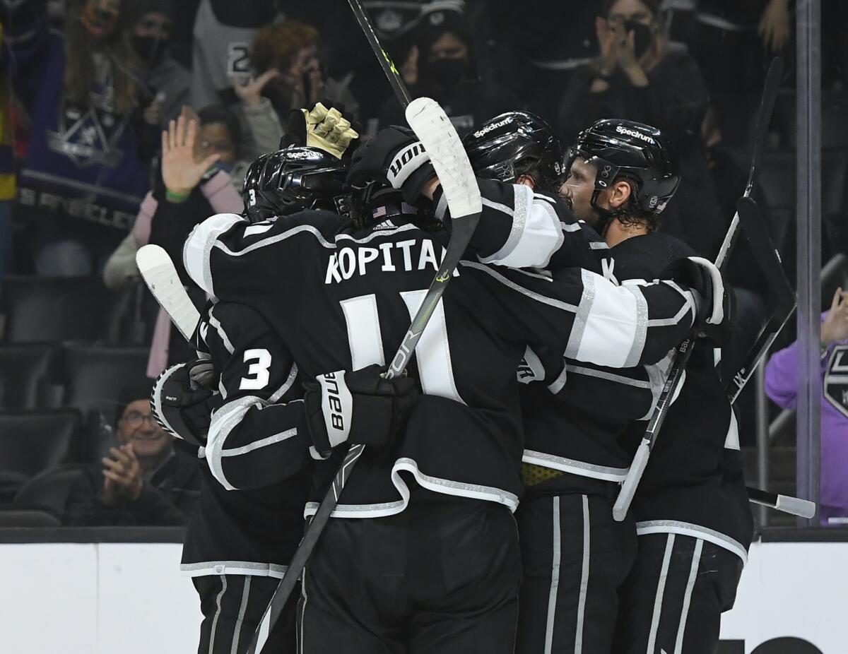 Kings players celebrate after forward Adrian Kempe scores against the New Jersey Devils in the second period.