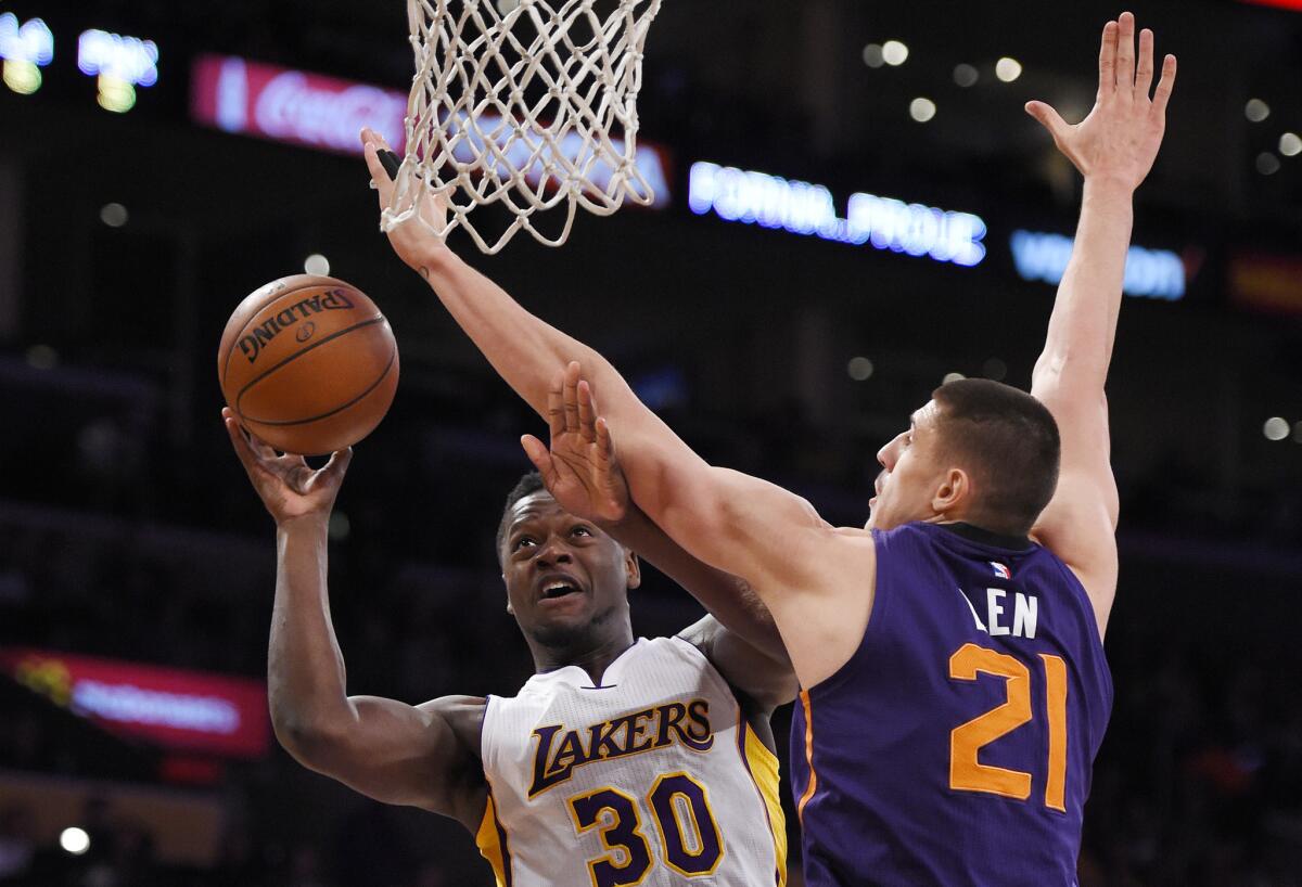Lakers forward Julius Randle shoots as Suns center Alex Len defends during the first half.