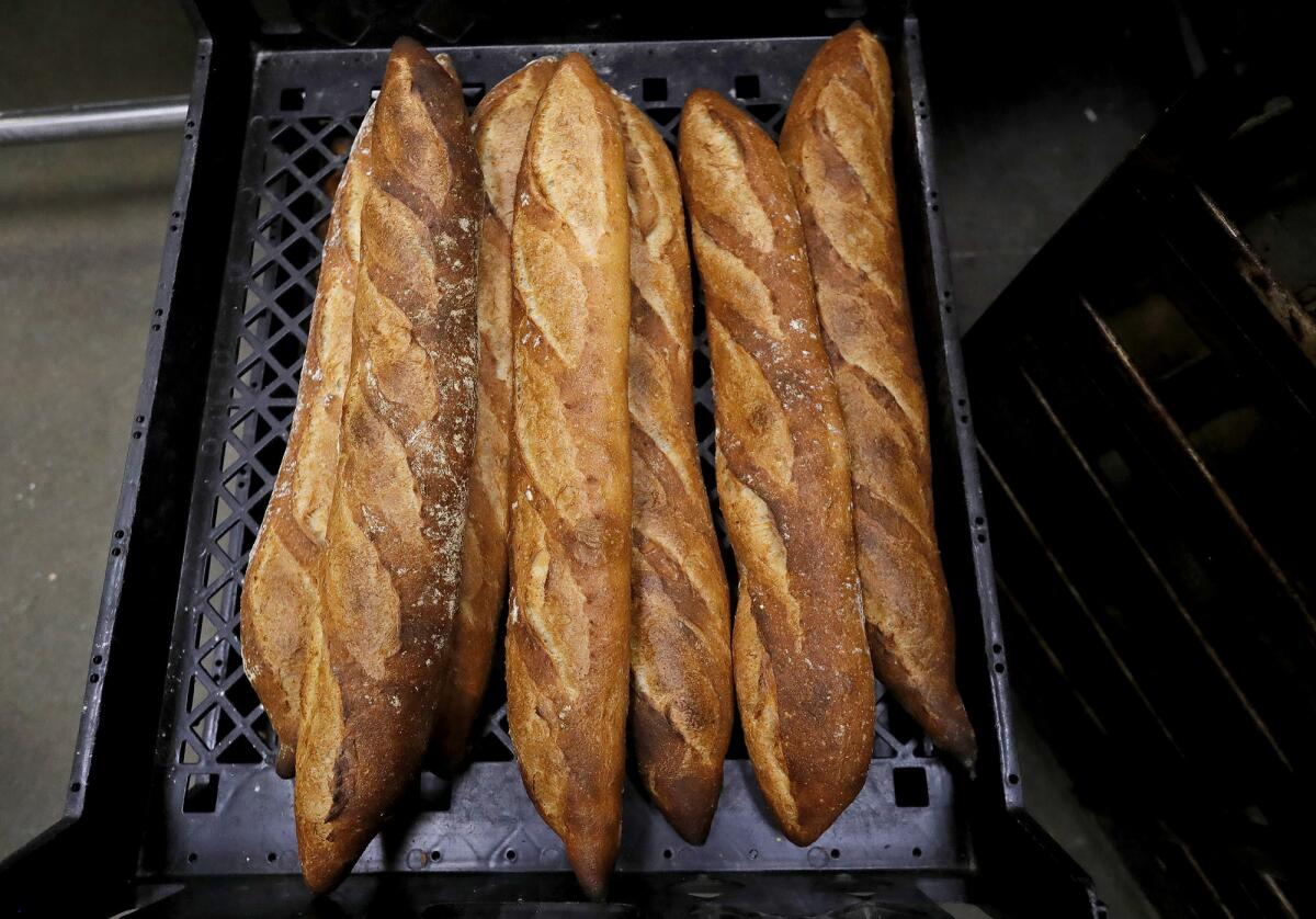 A stack of freshly baked baguettes, will soon be shipped to a local restaurant from the Bread Artisan Bakery in Santa Ana.