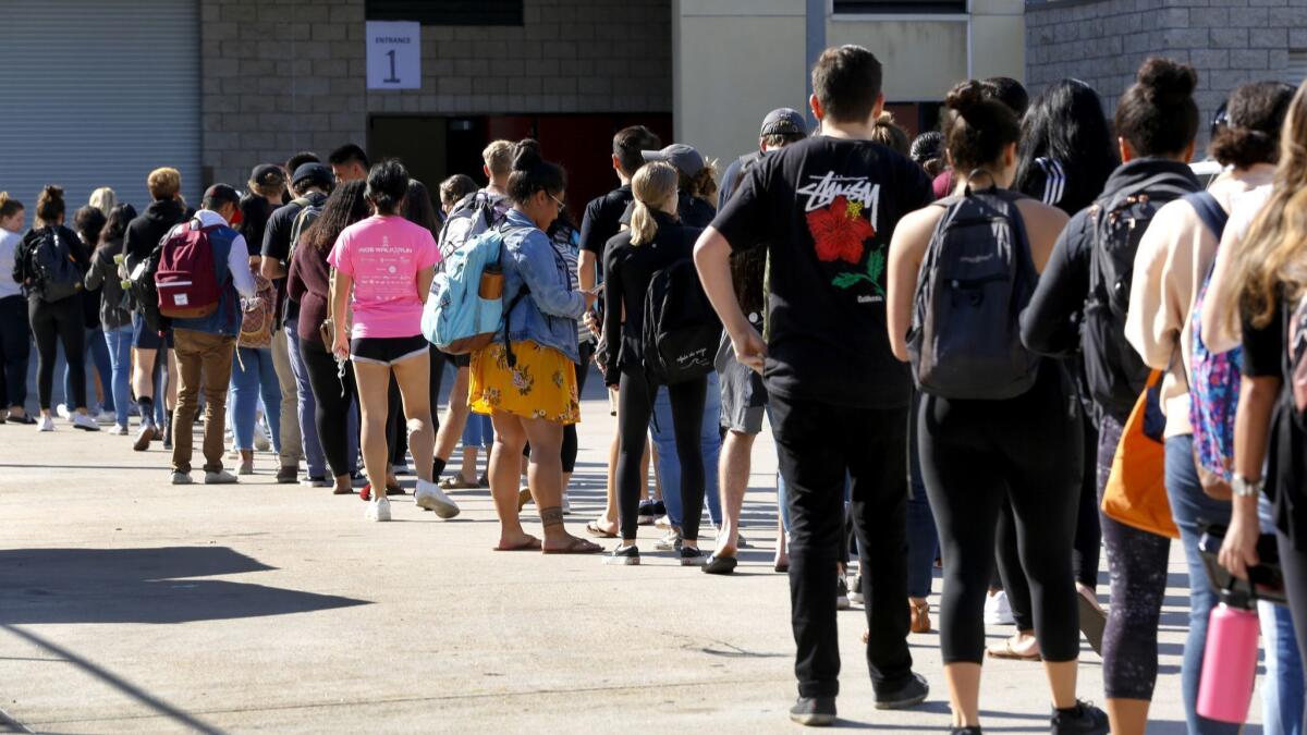 Students stand in line at Viejas Arena on the SDSU Campus to receive meningococcal disease vaccinations on Monday, Oct. 8. after an outbreak of type B infections was declared among undergraduates.