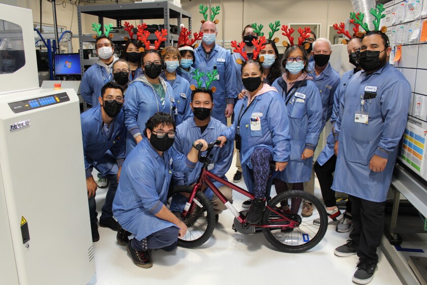 The team at Carlsbad’s HM Electronics came together to assemble 20 bikes to be distributed to children in foster care.