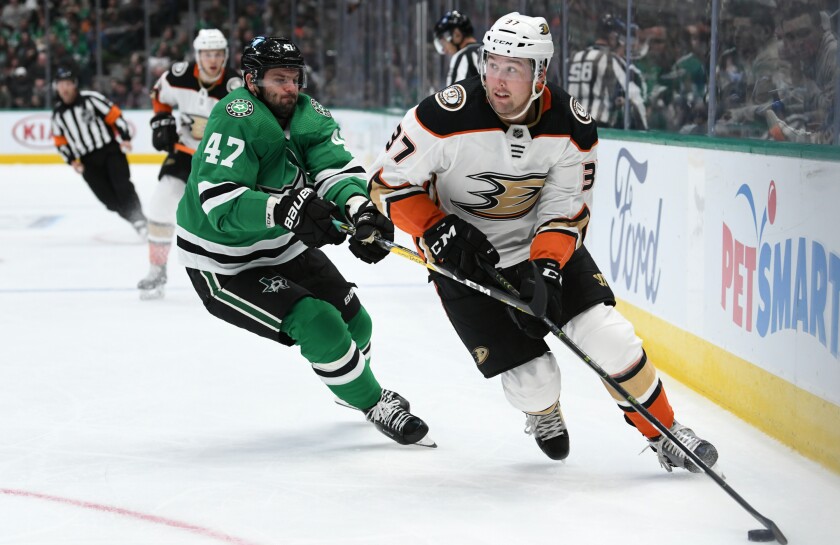Ducks forward Nick Ritchie controls the puck ahead of Dallas Stars forward Alexander Radulov during the Ducks' 2-1 loss.
