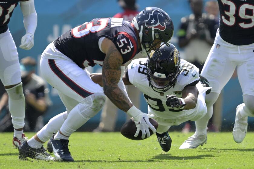 Houston Texans linebacker Blake Cashman (53) recovers the ball after Jacksonville Jaguars wide receiver Jamal Agnew (39) fumbled after making a catch during the first half of an NFL football game, Sunday, Sept. 24, 2023, in Jacksonville, Fla. (AP Photo/Phelan M. Ebenhack)