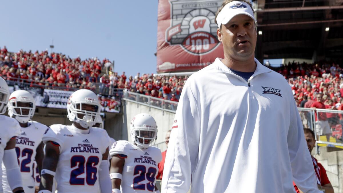 Florida Atlantic coach Lane Kiffin leads his team onto the field to play Wisconsin on Saturday.