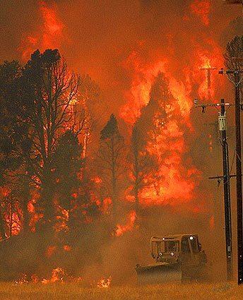 A bulldozer clears a fire break next to homes off Boy Scout Camp Road in Lockwood Valley.