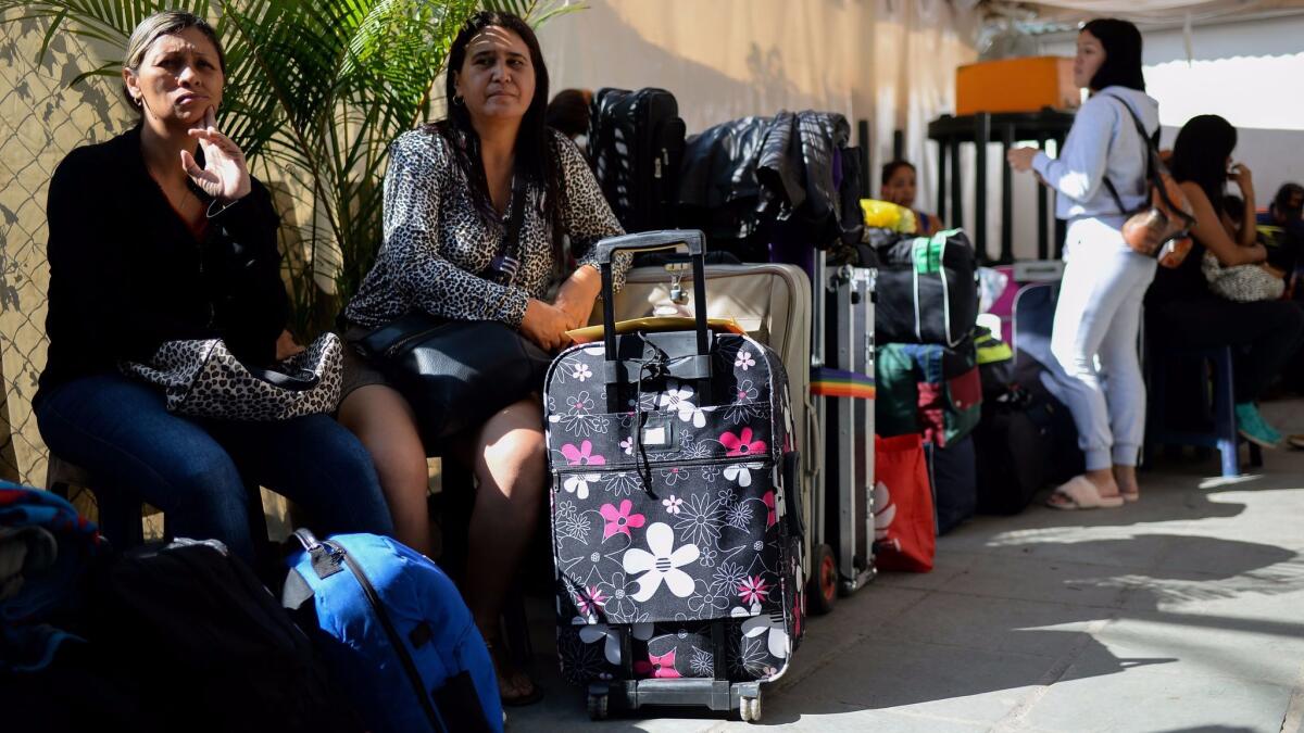 People queue at a Caracas bus terminal to buy tickets to travel to Ecuador, as Venezuelans who see no end to the economic crisis choose to leave the country.