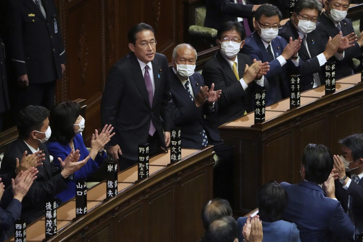 Japanese lawmakers applauding Prime Minister Fumio Kishida