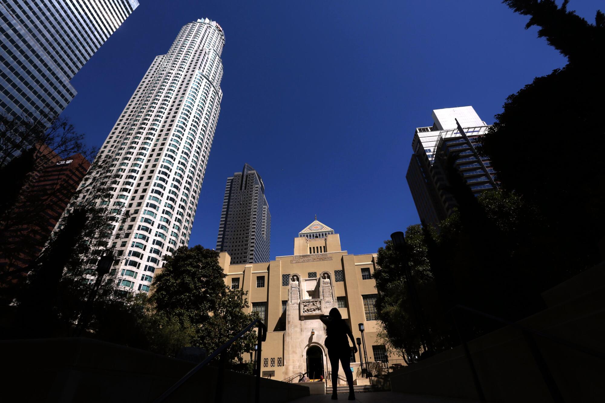 A visitor walks towards the Los Angeles Central Library in downtown Los Angeles