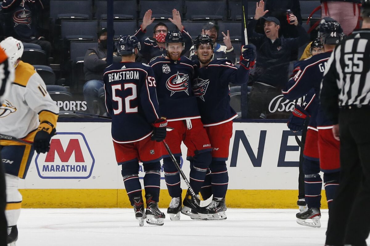 Columbus Blue Jackets' Mikhail Grigorenko, center, celebrate his goal against the Nashville Predators with Emil Bemstrom, left, and Jack Roslovic during the third period of an NHL hockey game Wednesday, May 5, 2021, in Columbus, Ohio. The Blue Jackets won 4-2. (AP Photo/Jay LaPrete)