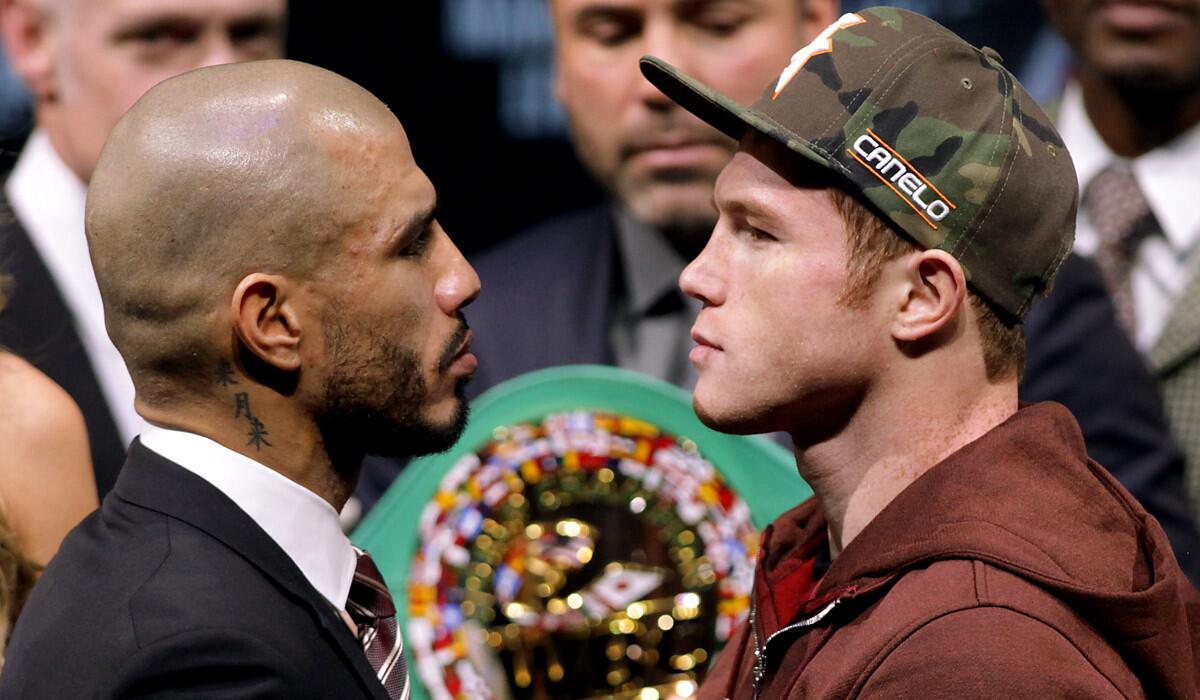 Miguel Cotto, left, and Saul "Canelo" Alvarez face off during a news conference Wednesday.