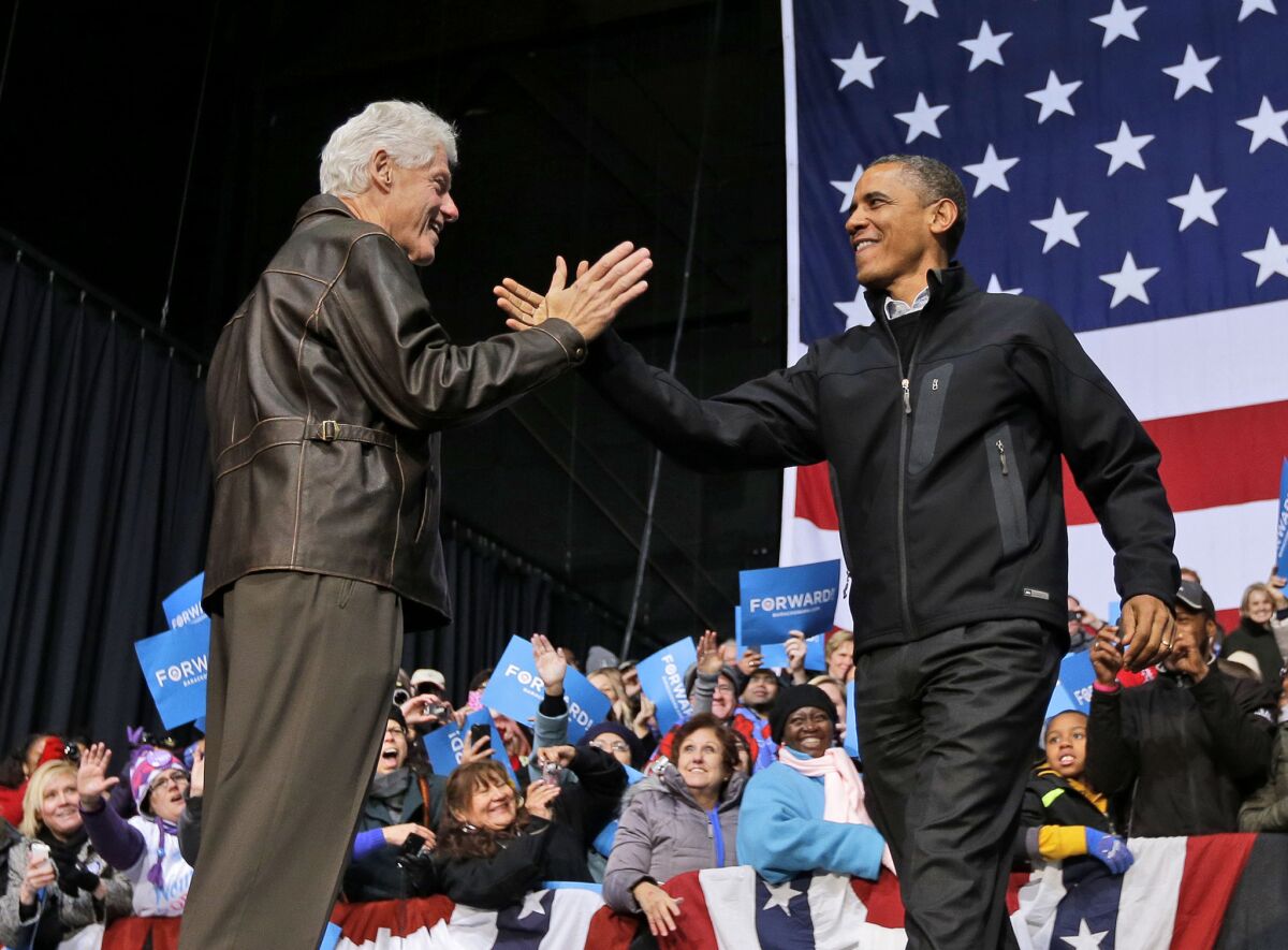 President Barack Obama, right, is introduced by former President Bill Clinton at a campaign event in Bristow, Va. on Nov. 3. Across 26 years of Democratic leadership, unemployment among blacks declined by 7.9%; under 28 years of Republican presidencies, the rate increased by a net of 13.7%, according to census data.