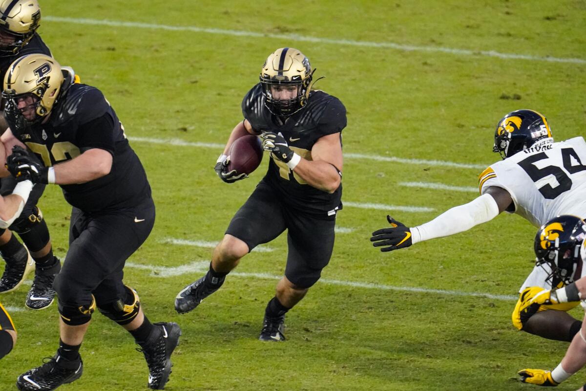 Purdue running back Zander Horvath (40) runs through the Iowa defense Saturday 