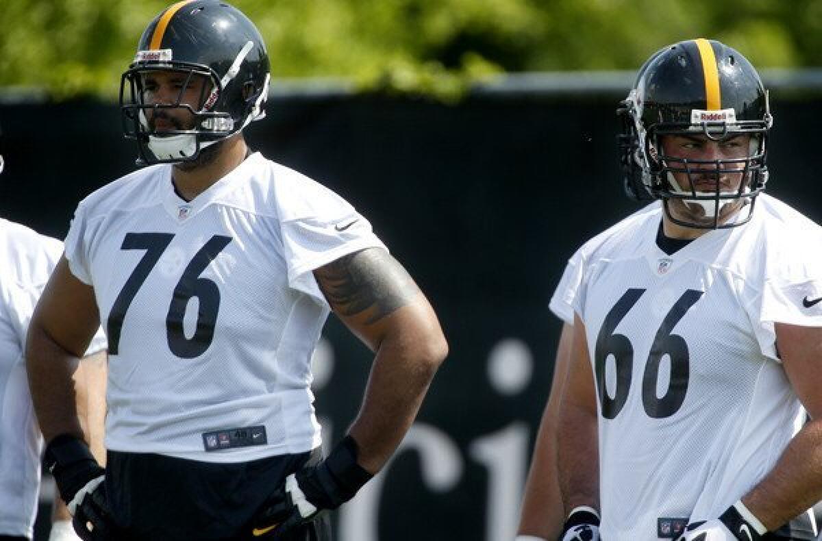 Steelers tackle Mike Adams (76) and guard David DeCastro (66) wait for the next drill during a practice in Pittsburgh.