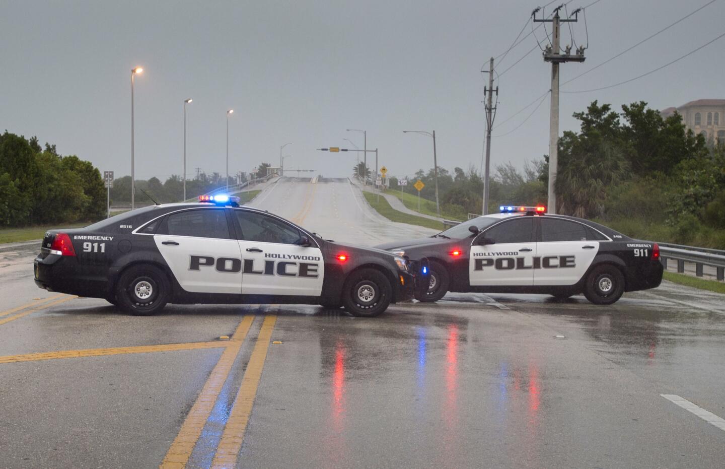 Police block a road leading to the oceanfront in Hollywood, Fla., on Sept. 9, 2017, as Hurricane Irma approaches the state.