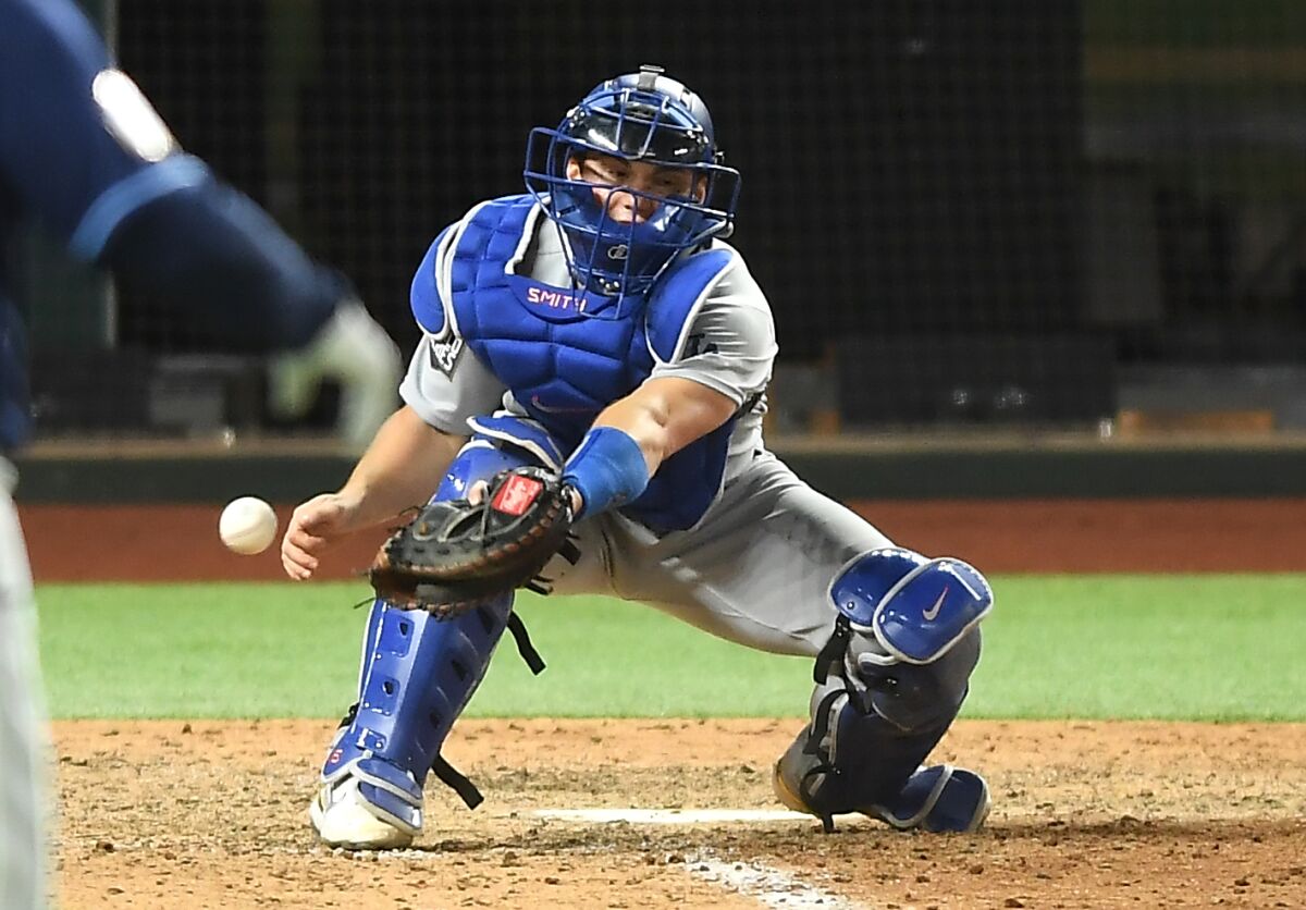Dodgers catcher Will Smith drops the ball, allowing Tampa Bay's Randy Arozarena to score the winning run.