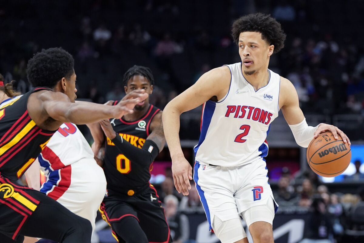 Detroit Pistons guard Cade Cunningham (2) looks to pass during the first half of an NBA basketball game against the Atlanta Hawks, Monday, March 7, 2022, in Detroit. (AP Photo/Carlos Osorio)