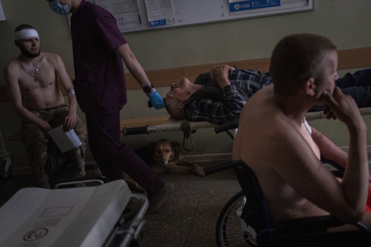 Ukrainian injured servicemen and an injured civilian wait for medical treatment in the Donetsk region, eastern Ukraine, Tuesday, June 7, 2022. (AP Photo/Bernat Armangue)