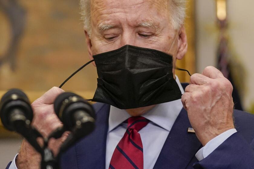 President Joe Biden removes his mask before speaking on the economy in the Roosevelt Room of the White House, Saturday, Feb. 27, 2021, in Washington. (AP Photo/Pablo Martinez Monsivais)
